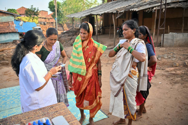 The doctor is explaining the appropriate medication dosage to a woman, demonstrating their commitment to providing vital healthcare services to underserved communities. The doctor is giving medicines to the woman, ensuring they have access to the necessary treatments for their healthcare needs. The photo captures the important work of healthcare professionals in remote areas, where medical camps play a crucial role in providing healthcare services to underserved communities.